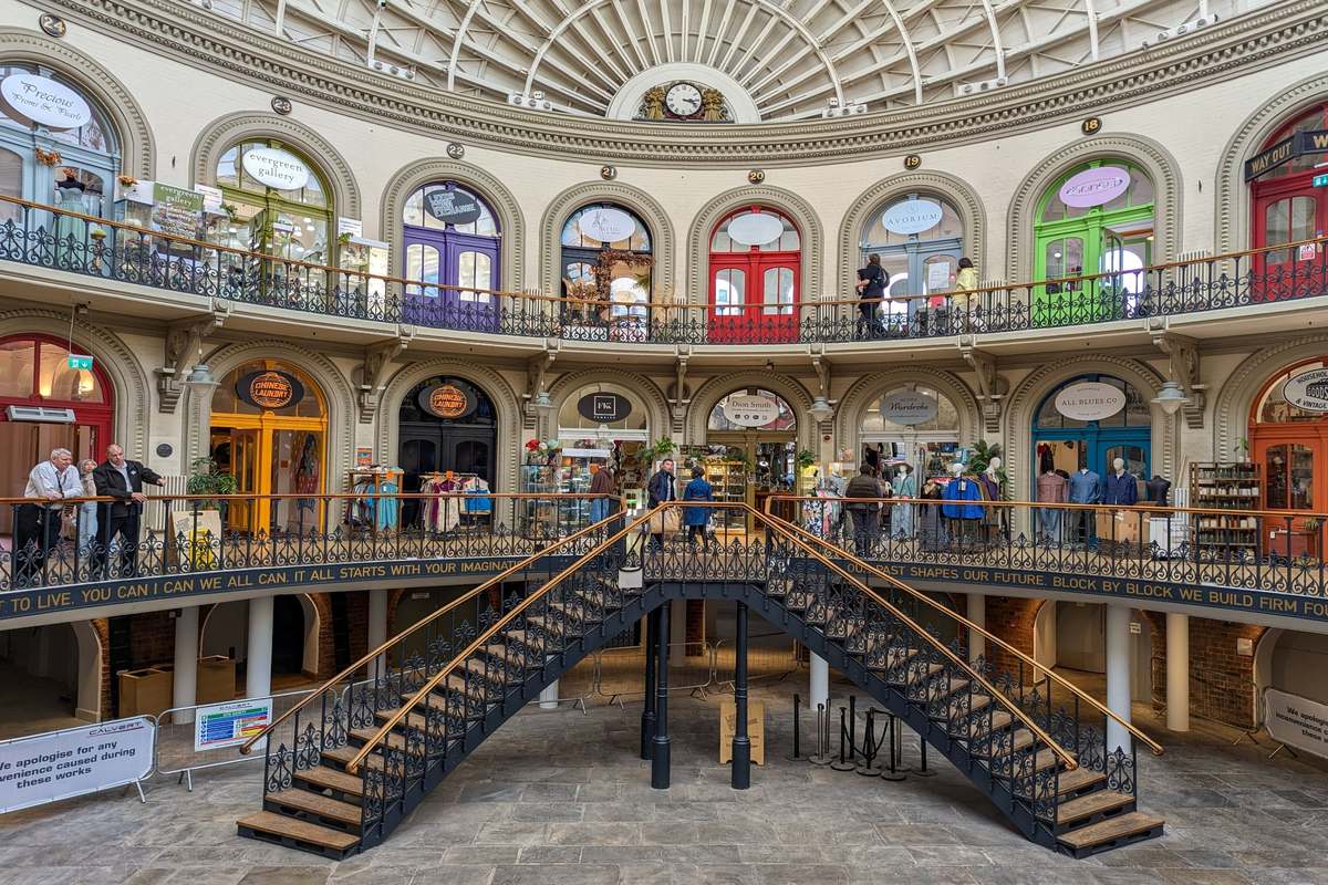 The stunning and colourful Corn Exchange in Leeds, featuring two staircases.